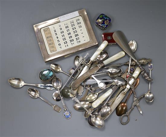 A silver mounted desk calendar, a 1920s silver, enamel and marcasite pill box and other items including silver flatware.